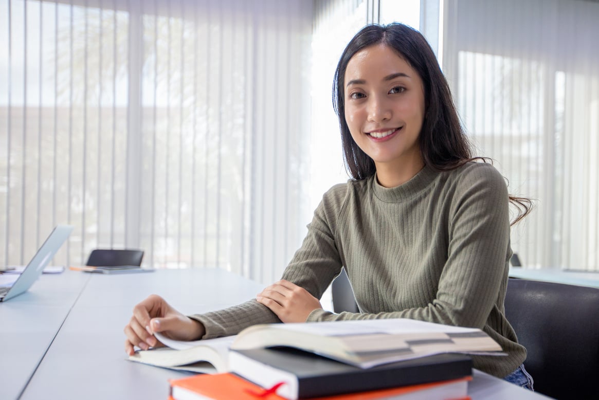 Female Student Smiling While Studying